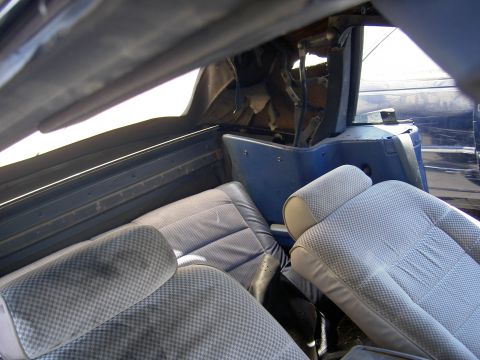 1982 Ford Mustang - The interior of a blue convertible is visible, including the seats and the mechanism for the convertible top.