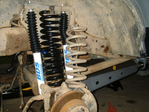 1991 Ford Bronco - Comparison of old and new suspension parts, showing new BDS shocks and springs installed.