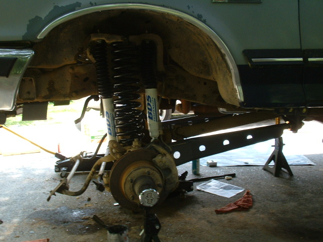 1991 Ford Bronco front suspension with dual shocks and springs on jack stands