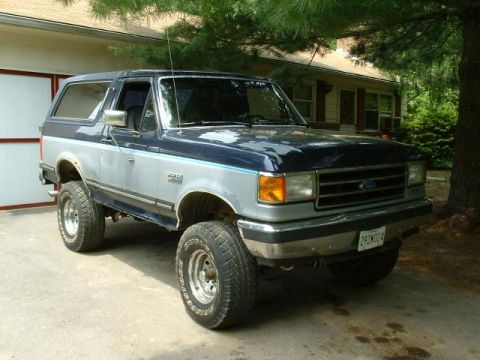 1991 Ford Bronco - This 1991 Ford Bronco is parked outside a house with a garage.