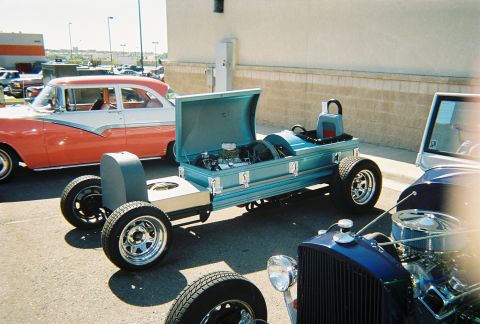 1972 Ford Ranchero - A unique coffin-shaped vehicle is displayed alongside other cars, with its engine and interior visible.