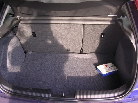 1985 Ford Bronco - Interior view of a car's trunk, which contains a first aid kit.