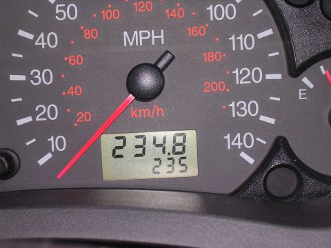 1985 Ford Bronco - Close-up of a car's dashboard displays the speedometer and odometer readings.