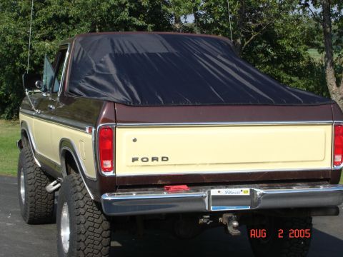1979 Ford Bronco - This 1979 Ford Bronco features a two-tone brown and tan paint scheme with a black soft top covering the rear.