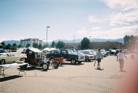 1972 Ford Ranchero - Outdoor car show with multiple vehicles including a custom hot rod and a black pickup truck.