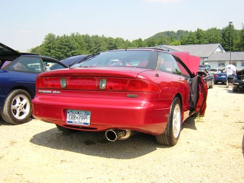 1995 Ford Probe - Rear view of a red 1995 Ford Probe GT, showing its taillights, exhaust, and license plate.