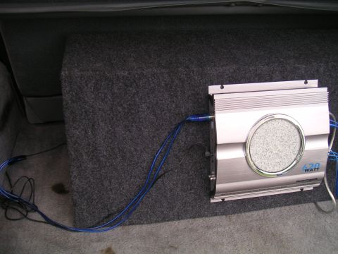 1994 Ford Bronco - A car subwoofer and amplifier are installed in the trunk of a vehicle.