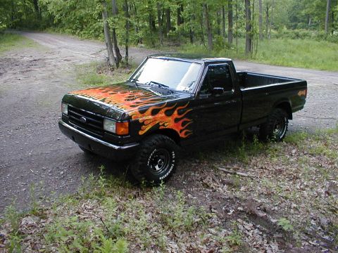1991 Ford F-150 - This 1991 Ford F-150 features a custom flame paint job on its exterior.