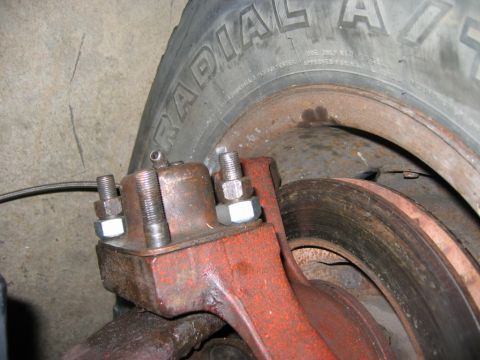 1985 Ford Bronco - Brake caliper and rotor assembly shown with a tire in the background.