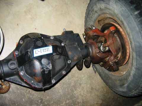1985 Ford Bronco - Differential assembly with a C-FAB sticker and a tire, likely a component for a heavy-duty vehicle.
