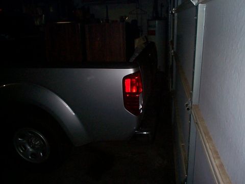 2005 Nissan Frontier - Rear view of a silver 2005 Nissan Frontier pickup truck inside a garage.