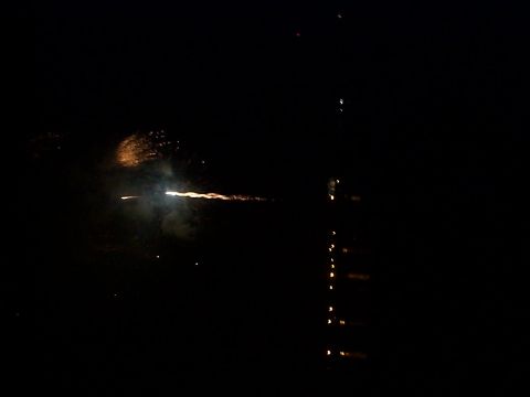 2005 Nissan Frontier - A nighttime scene captures fireworks illuminating the dark sky, with their reflections shimmering on the water's surface.
