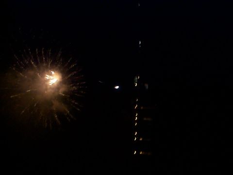 2005 Nissan Frontier - A nighttime scene captures fireworks and a distant tower with lights.