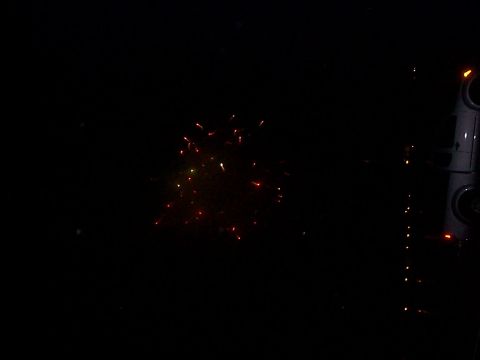 2005 Nissan Frontier - Fireworks explode in the night sky behind a dark vehicle, with the Supermotors logo visible at the bottom.