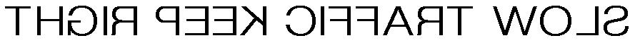 Mirror-reversed black text on white reading SLOW TRAFFIC KEEP RIGHT