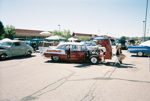 1972 Ford Ranchero - Customized 1955 Chevrolet 210 drag car on display at an outdoor car show.