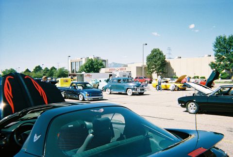 1972 Ford Ranchero - A variety of vehicles are gathered at an outdoor event, with several hoods open for display.