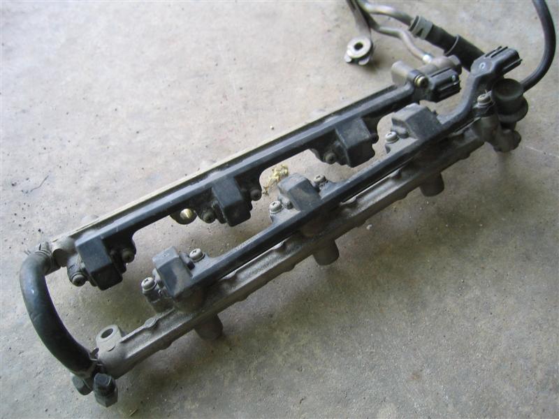 Fuel rail with injectors on concrete surface