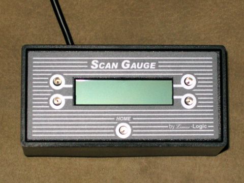 2000 Ford Crown Victoria - A Scan Gauge device, a diagnostic tool for vehicles, is shown close-up against a textured background.