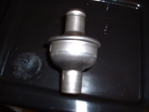 1978 Ford Mustang II - This is a metal automotive part, likely a valve or fitting, with two hose connection points.