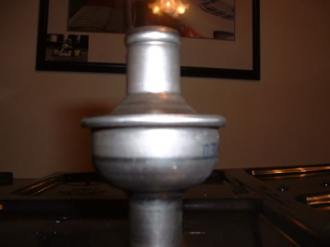 1978 Ford Mustang II - Close-up of a metal thermostat housing, likely a replacement part.