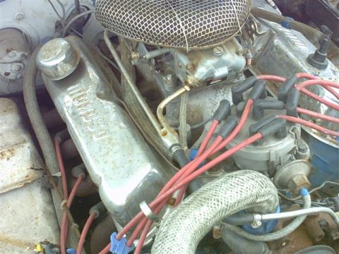 1978 Ford Mustang II - Engine-bay close-up of a small-block V8 with an embossed chrome valve cover and twist-on oil filler cap, a mesh-topped chrome air cleaner o…
