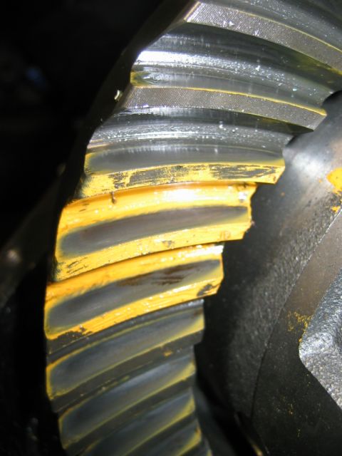 1985 Ford Bronco - Damaged differential gear teeth show wear and chipping, with yellow paint remnants visible.