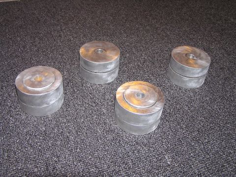 1993 Ford Taurus - Four cylindrical metal objects are arranged on a carpeted surface.