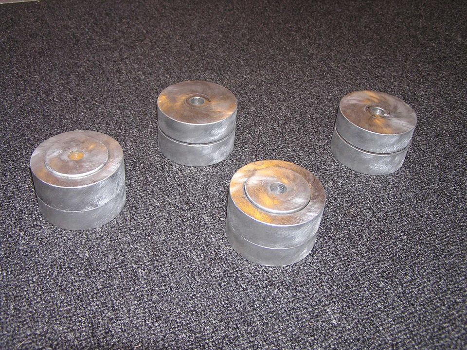 four metal cylinders on carpet