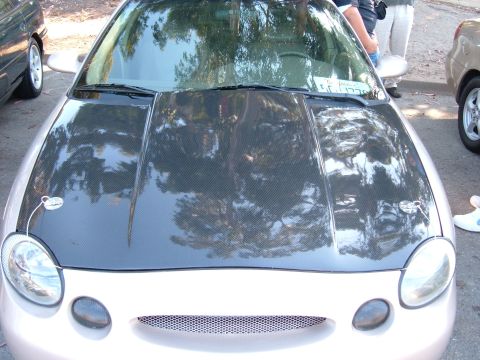 1995 Ford Taurus - The front of a 1996 Ford Taurus is shown with a carbon fiber hood and aftermarket hood pins.
