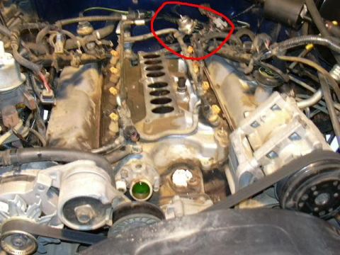 1988 Ford Bronco - Close-up view of an engine bay, focusing on the intake manifold and associated components.