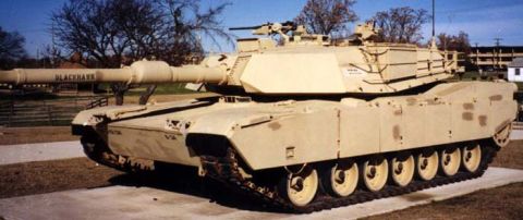 1973 Ford Ranchero - A tan military tank with a large cannon is displayed outdoors.