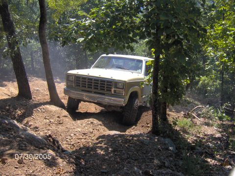 1978 Ford Bronco - This Ford Bronco navigates a challenging off-road trail, kicking up dust.