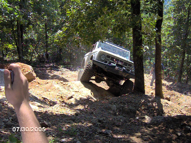White 1978 Ford Bronco climbing rocky terrain