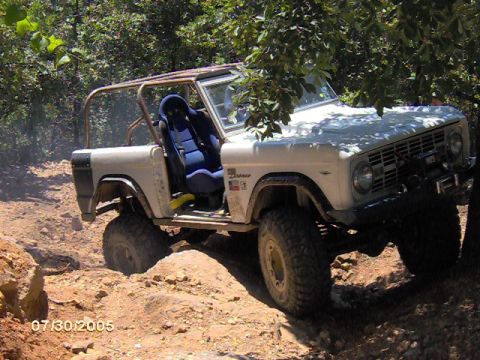 1978 Ford Bronco - 1978 Ford Bronco tackling rough terrain with its off-road modifications.