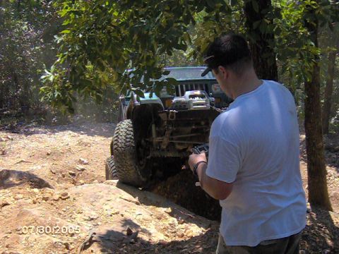 1978 Ford Bronco - A man films an off-road vehicle navigating a rocky trail on a sunny day.