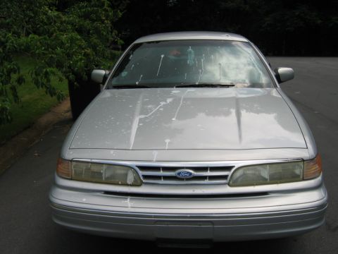 1985 Ford LTD Crown Victoria - This silver Ford Crown Victoria has white splatters on its hood and windshield.