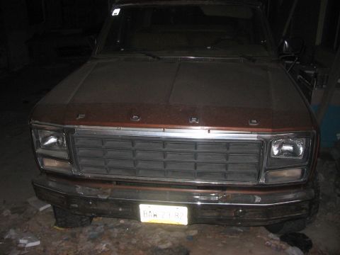 1986 Ford Bronco - This 1980s Ford truck is shown from the front, a prominent grille and a license plate.