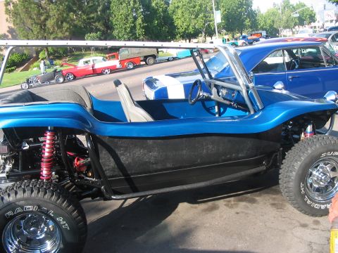 1986 Ford Bronco - A custom blue dune buggy is parked on the street, with other vehicles visible in the background.