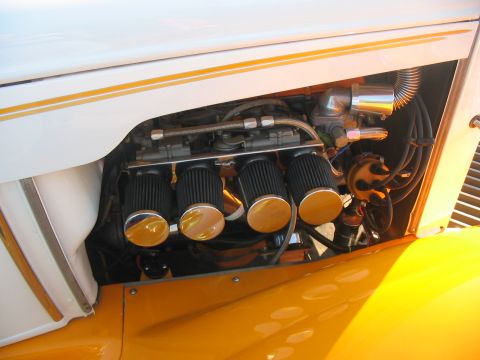 1986 Ford Bronco - Close-up of a custom engine setup four carburetors with air filters and chrome accents.