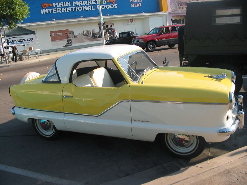 Yellow and white Nash Metropolitan coupe, side view