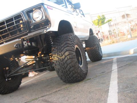 1986 Ford Bronco - This heavily modified truck features oversized tires and a lifted suspension, giving it an aggressive stance.