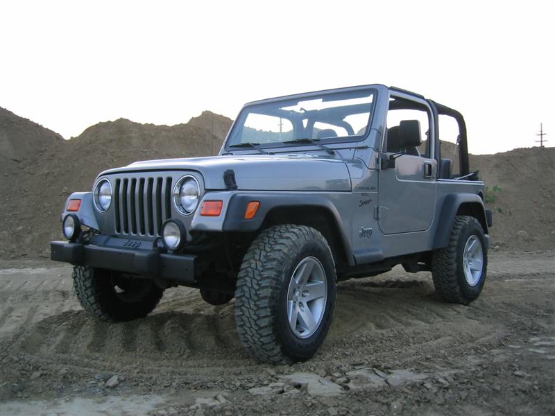 Gray Jeep Wrangler with a 2000 badge on the grille