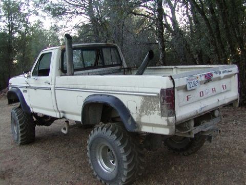 1995 Ford Bronco - This lifted Ford pickup truck has a distinctive body style and large exhaust pipes.