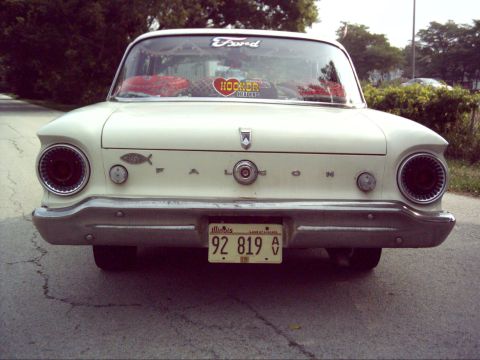 1962 Ford Falcon - The rear of a white 1962 Ford Falcon shows its distinctive taillights and chrome bumper.