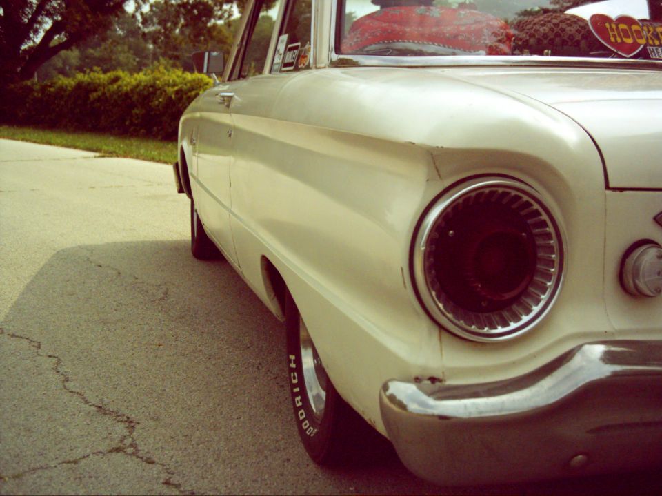White 1962 Ford Falcon rear quarter panel with round taillight and chrome bumper