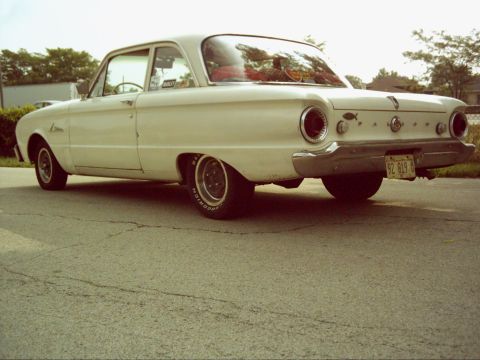 1962 Ford Falcon - Rear view of a white 1962 Ford Falcon with custom wheels parked on asphalt.
