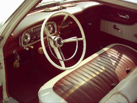 1962 Ford Falcon - Interior view of a 1962 Ford Falcon, showing the dashboard, steering wheel, and front seat.