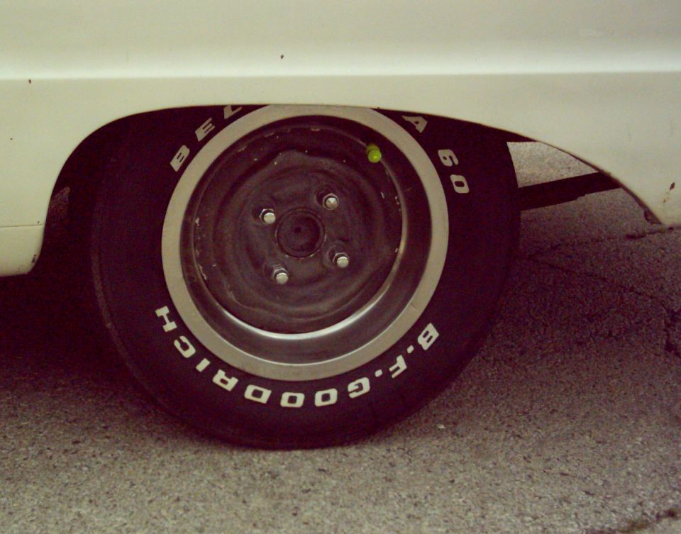 Close-up of a car's rear wheel with BFGoodrich Radial T/A tires and a white fender
