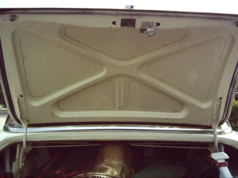 1962 Ford Falcon - Interior of the trunk of a 1962 Ford Falcon, showing the underside of the lid and some engine parts.